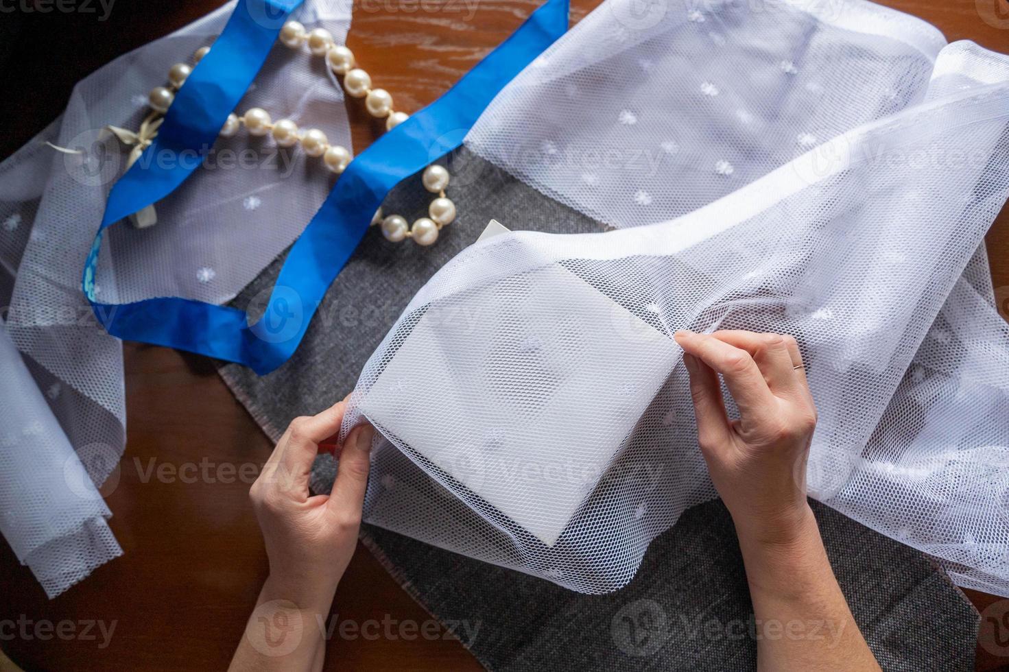 Hands pack the box with eco materials and textiles photo