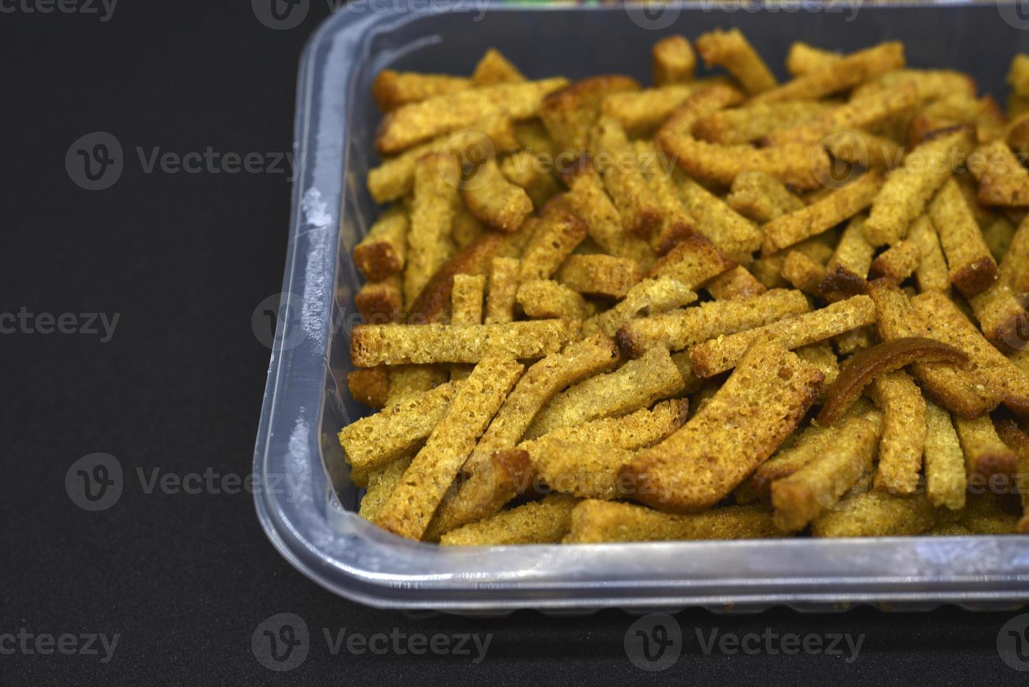 Breadcrumbs in a box. Bread snack for beer. Dried baked bread. 20213456