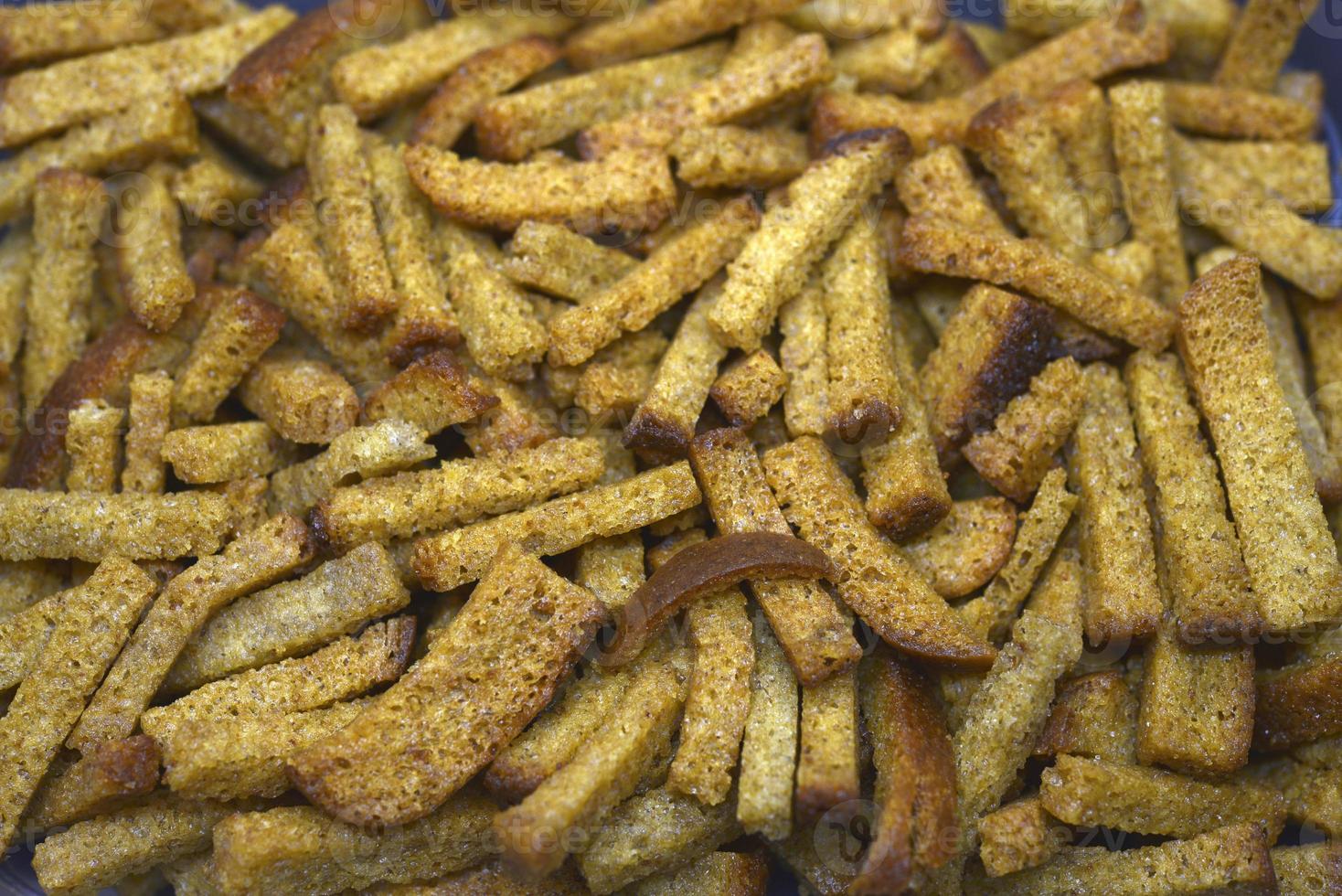 Breadcrumbs in a box. Bread snack for beer. Dried baked bread. photo