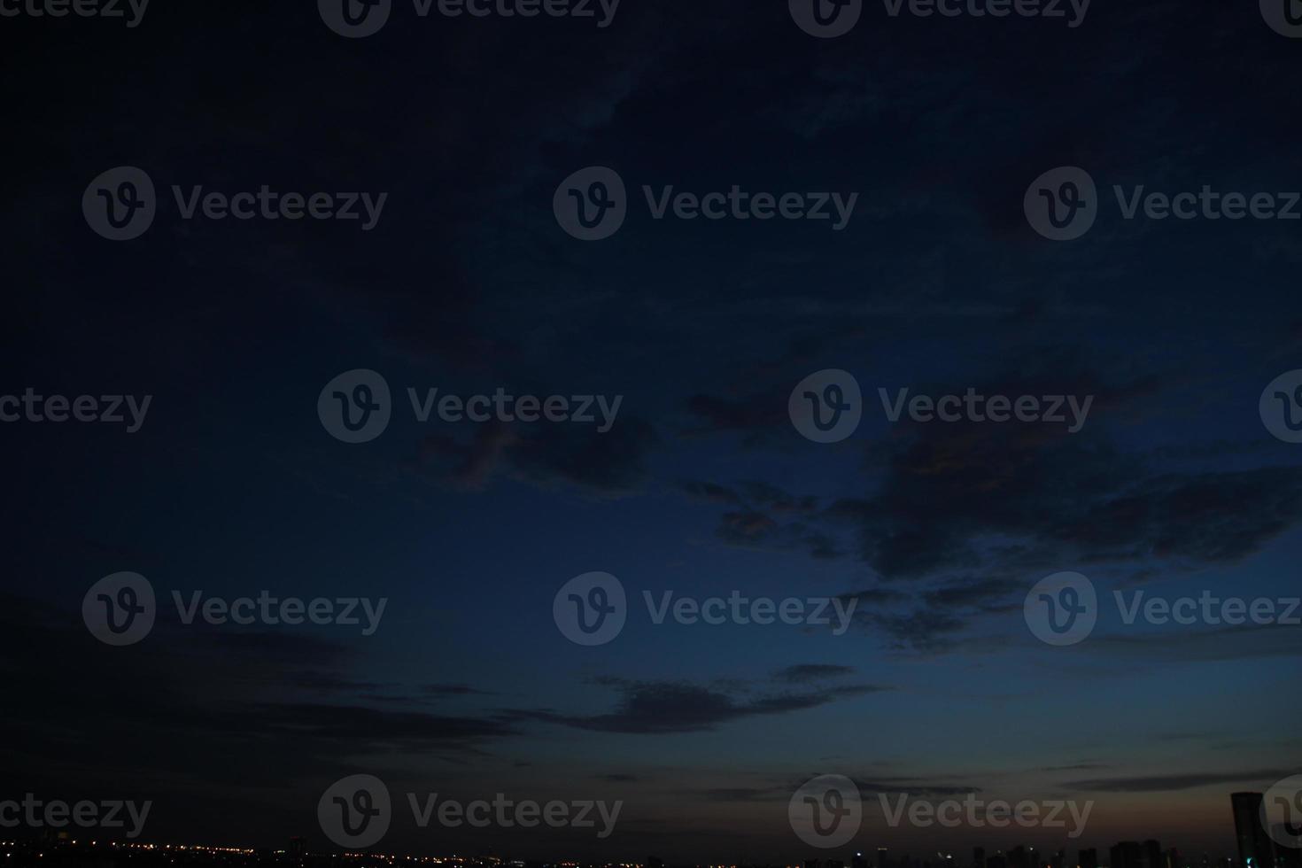 dark blue cloud with white light sky background and city light midnight evening time photo