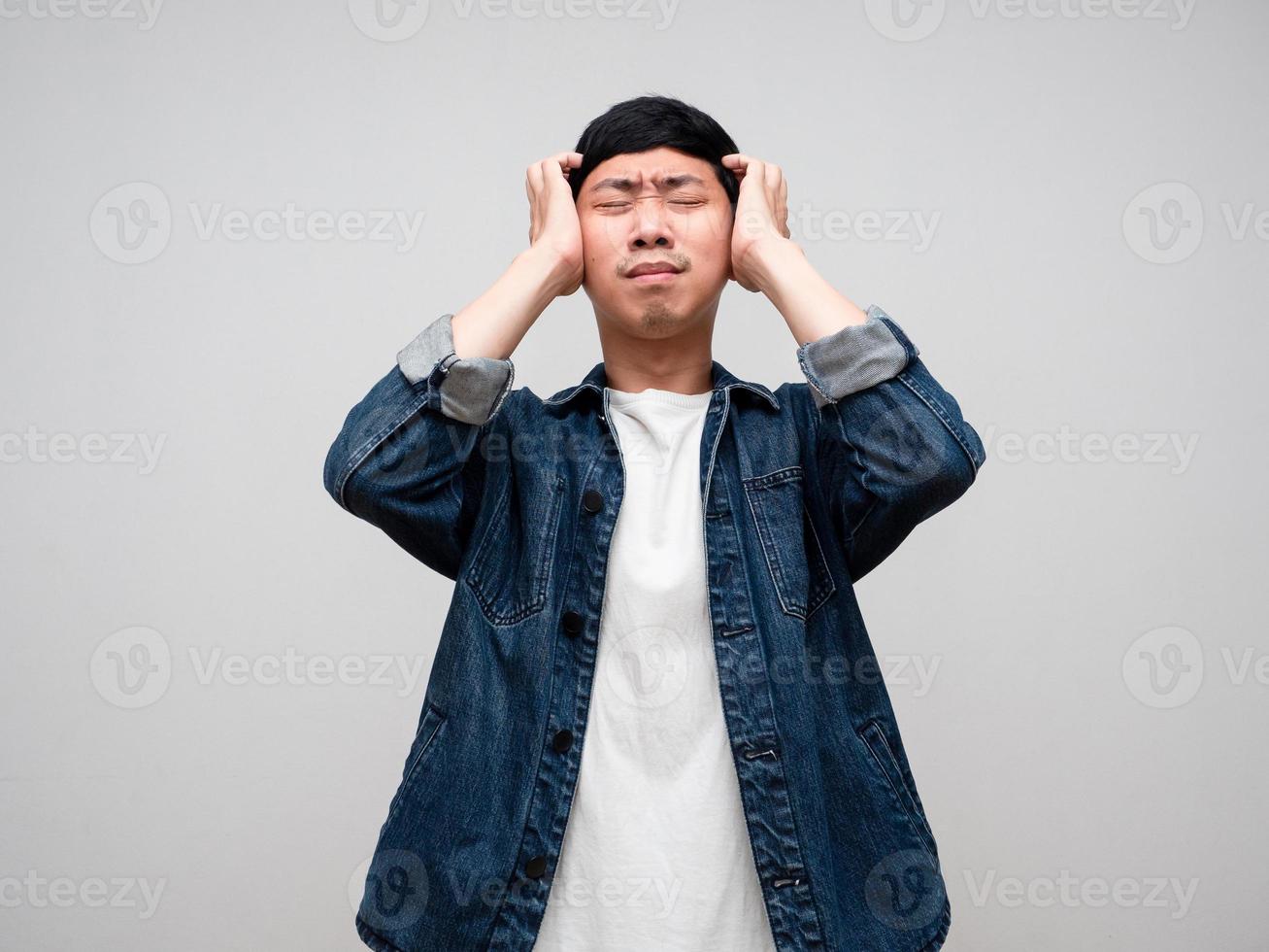 Sadness asian man jeans shirt feels disheartened,cry,headache isolated photo