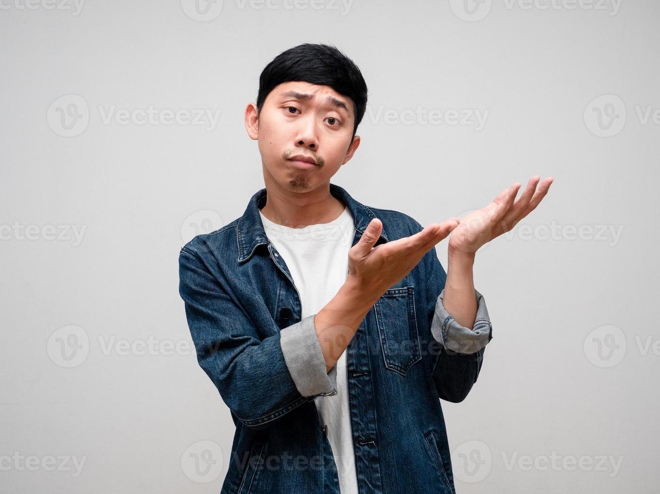 Negative asian man jeans shirt feels confused and doubt gesture point hands isolated photo