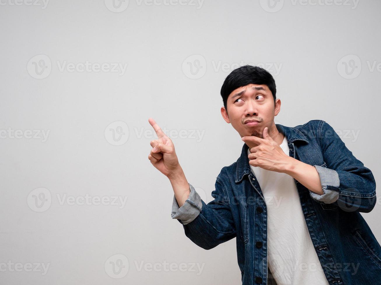 Negative asian man jeans shirt feels confused and doubt gesture point finger isolated photo