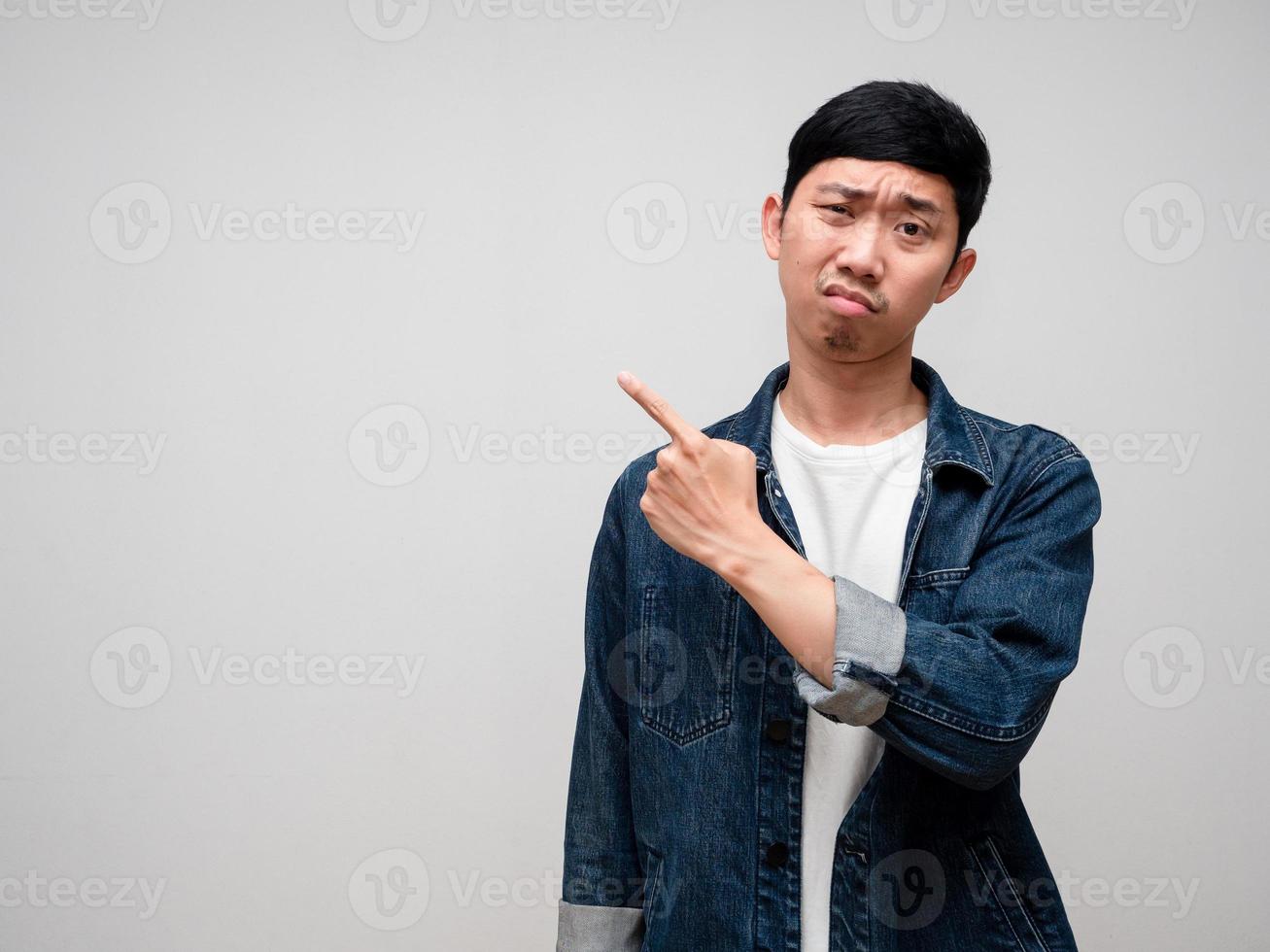 Negative asian man jeans shirt feels confused and doubt gesture point finger isolated photo