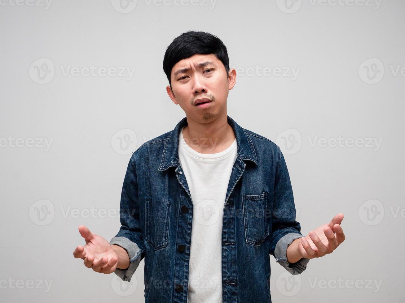 Negative asian man jeans shirt feels tried and confused about working isolated photo