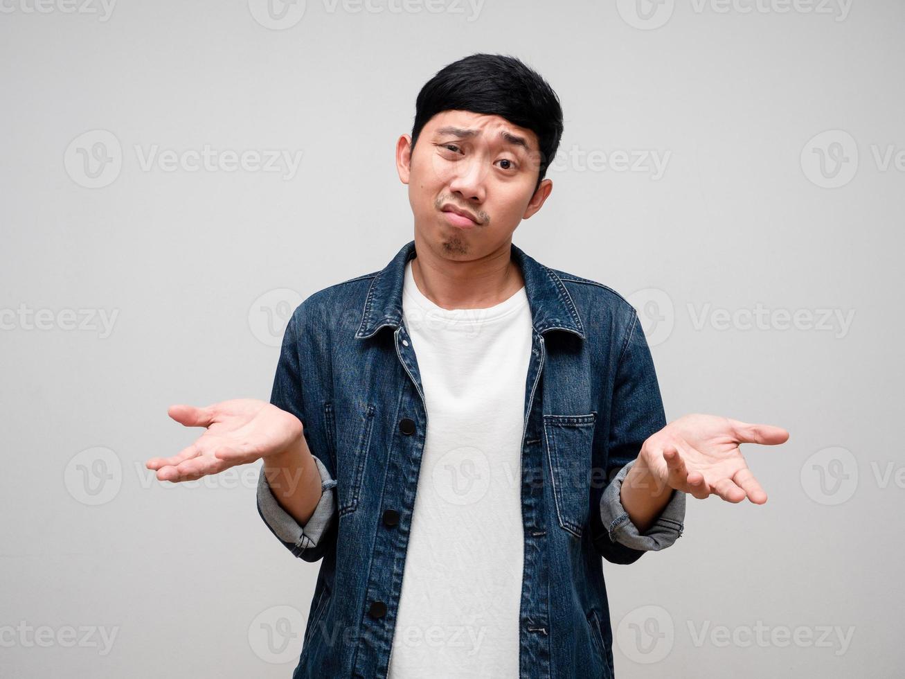 Negative asian man jeans shirt feels tried and confused about working isolated photo