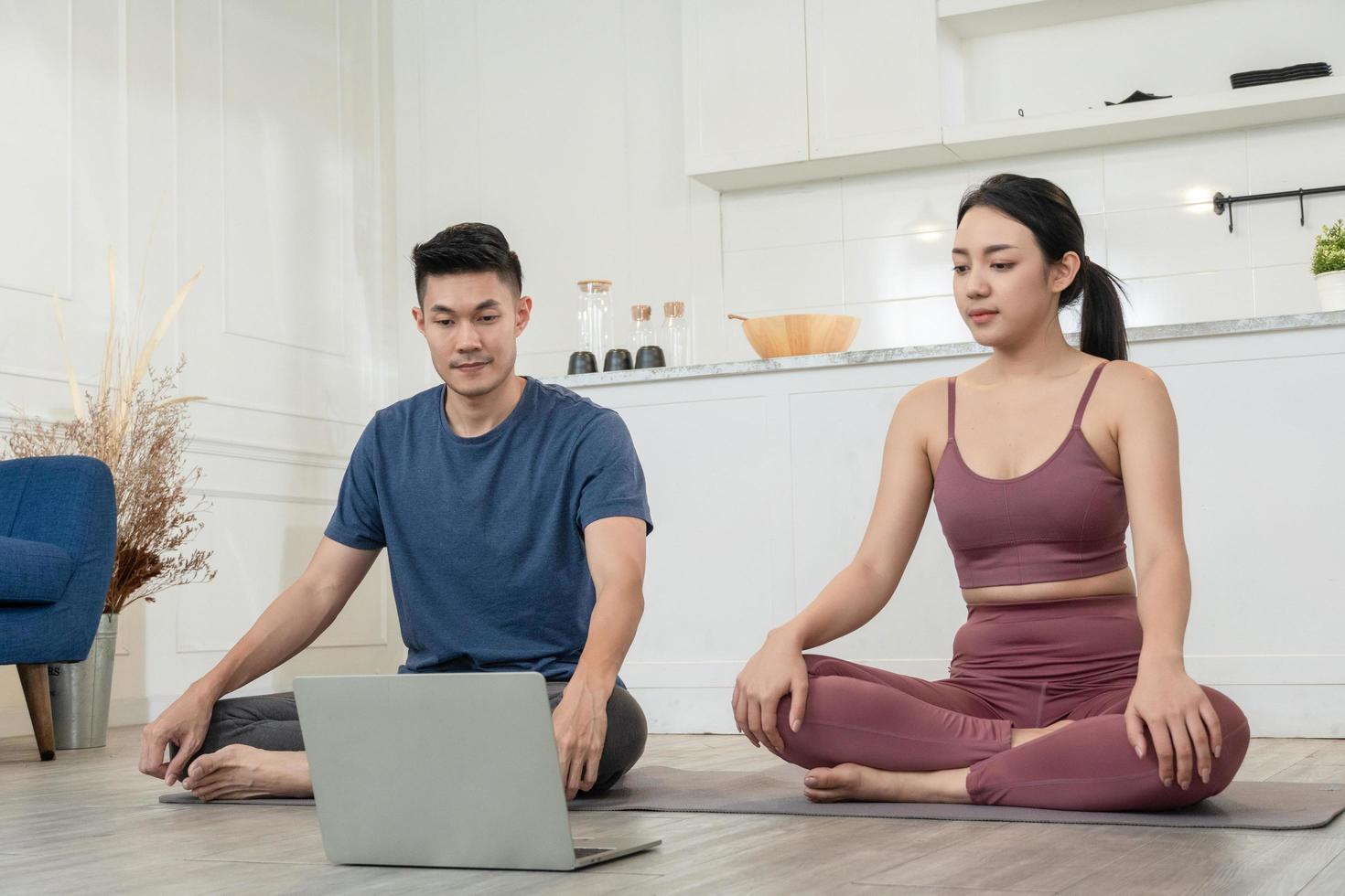 Asian couple watching exercise tutorial practice at home photo