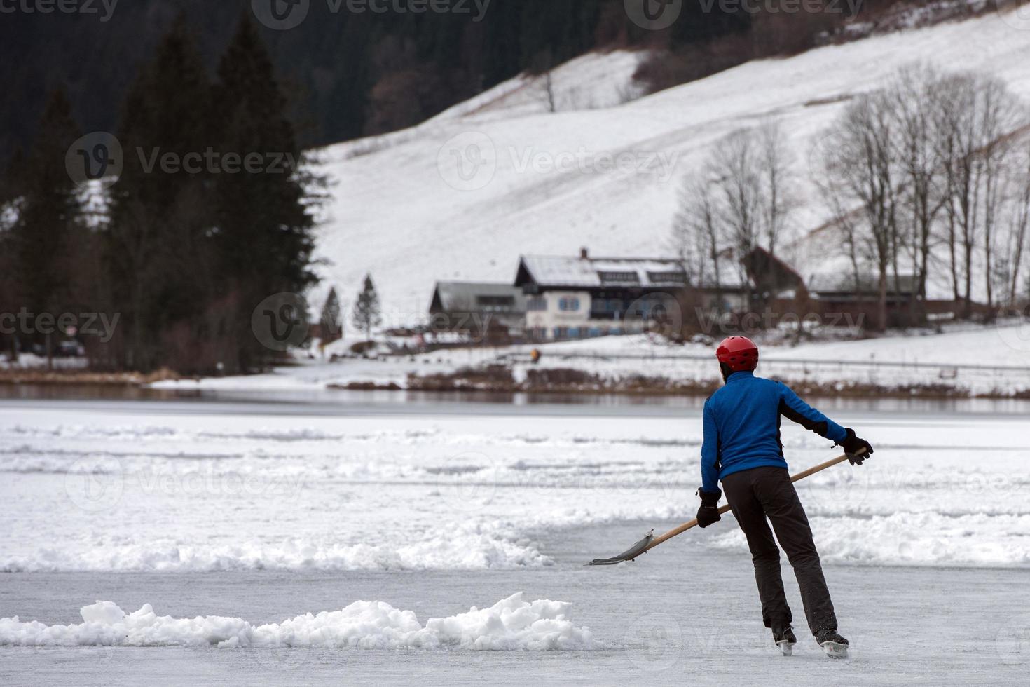 people playing hockey on frozen lake photo