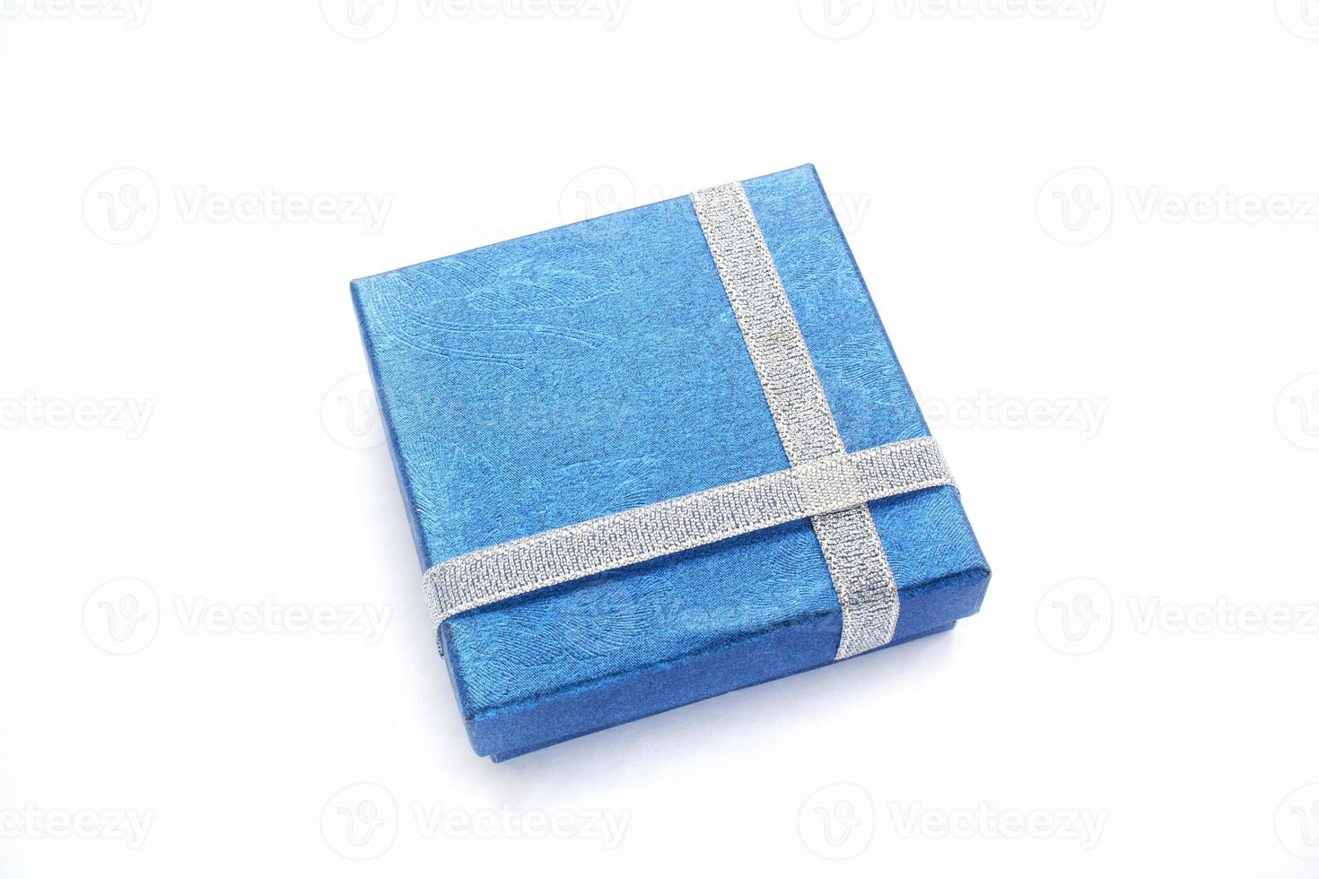 Blue gift box with silver ribbon on white background. Wedding, birthday, Valentine's Day, Mother's Day, Women's Day concept. Idea for congratulation, invitation, greeting card. Flatlay, top view photo