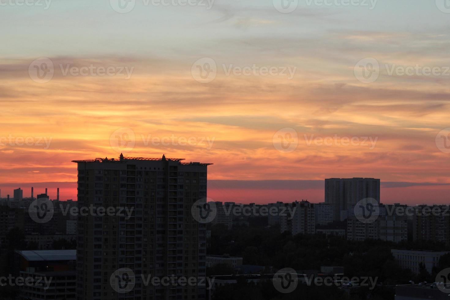 Colorful cloudy twilight beautiful sky cityscape sunset and morning sunrise. Dramatic evening night early morning view with city buildings silhouette. Panoramic background concept. Copy space for text photo