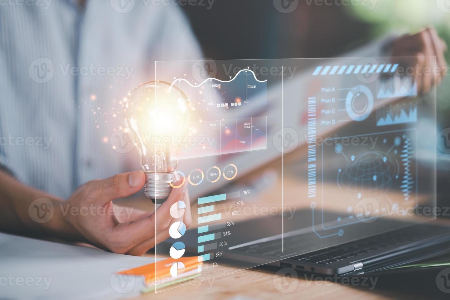businessman holding a light bulb ,business statistic chart report to analyze and improve corporate strategy ,Financial document management ,Annual budget account updates ,Company growth planning photo