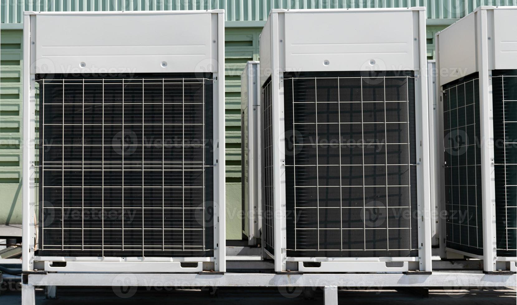 Compressors, air conditioners on the roof of the office building photo