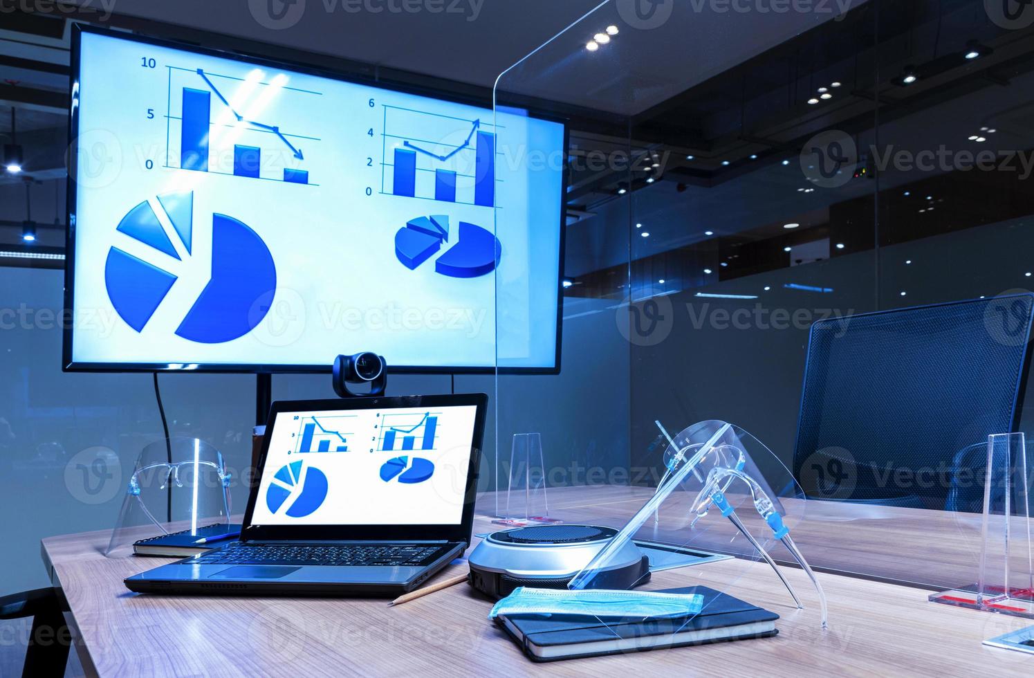 Mock up chart diagram presentation on display laptop and television in meeting room photo