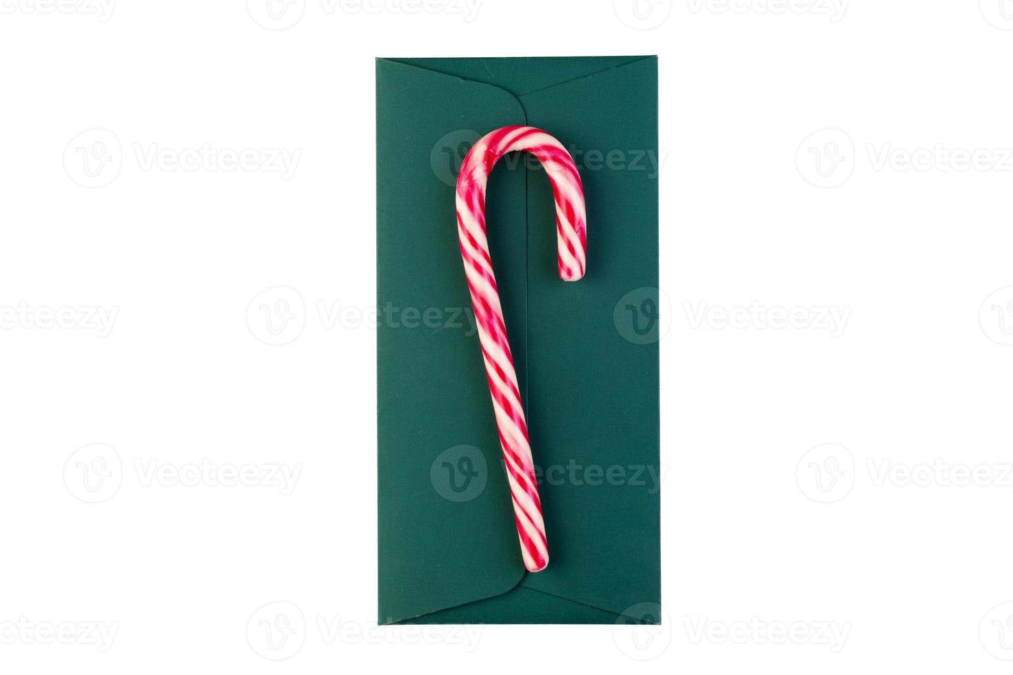 6557 Red candy cane on a green envelope isolated on a transparent background photo