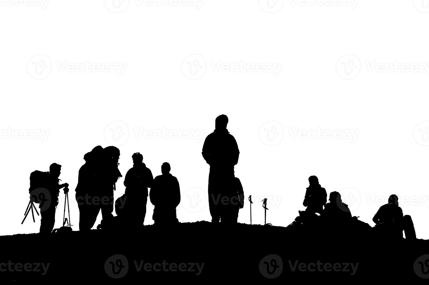 A group of trekkers black silhouette in the cloudy sky background photo