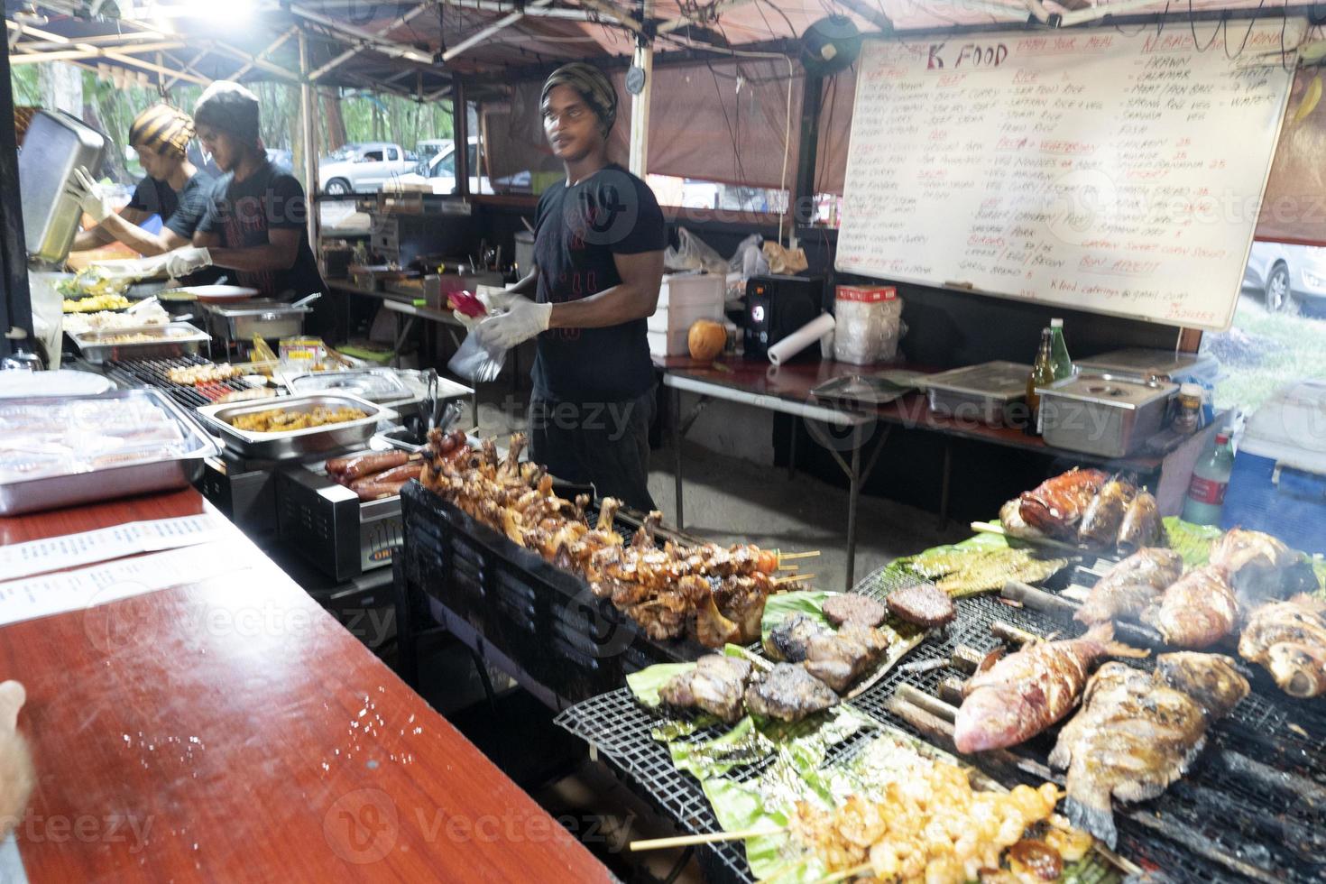 MAHE, SEYCHELLES - AUGUST 13 2019 - Young creole people at local market photo