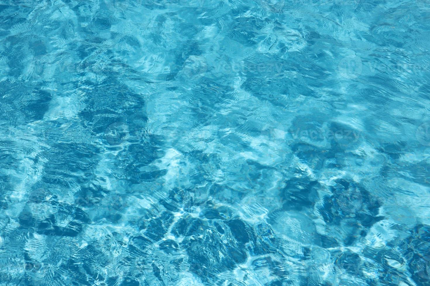 Blue water in swimming pool outdoors under the shiny sunlight photo