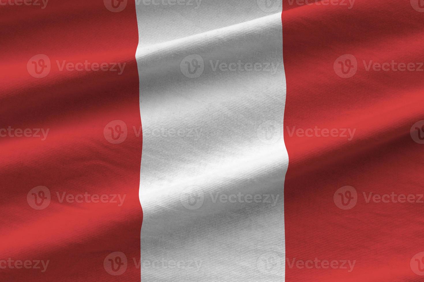 Peru flag with big folds waving close up under the studio light indoors. The official symbols and colors in banner photo