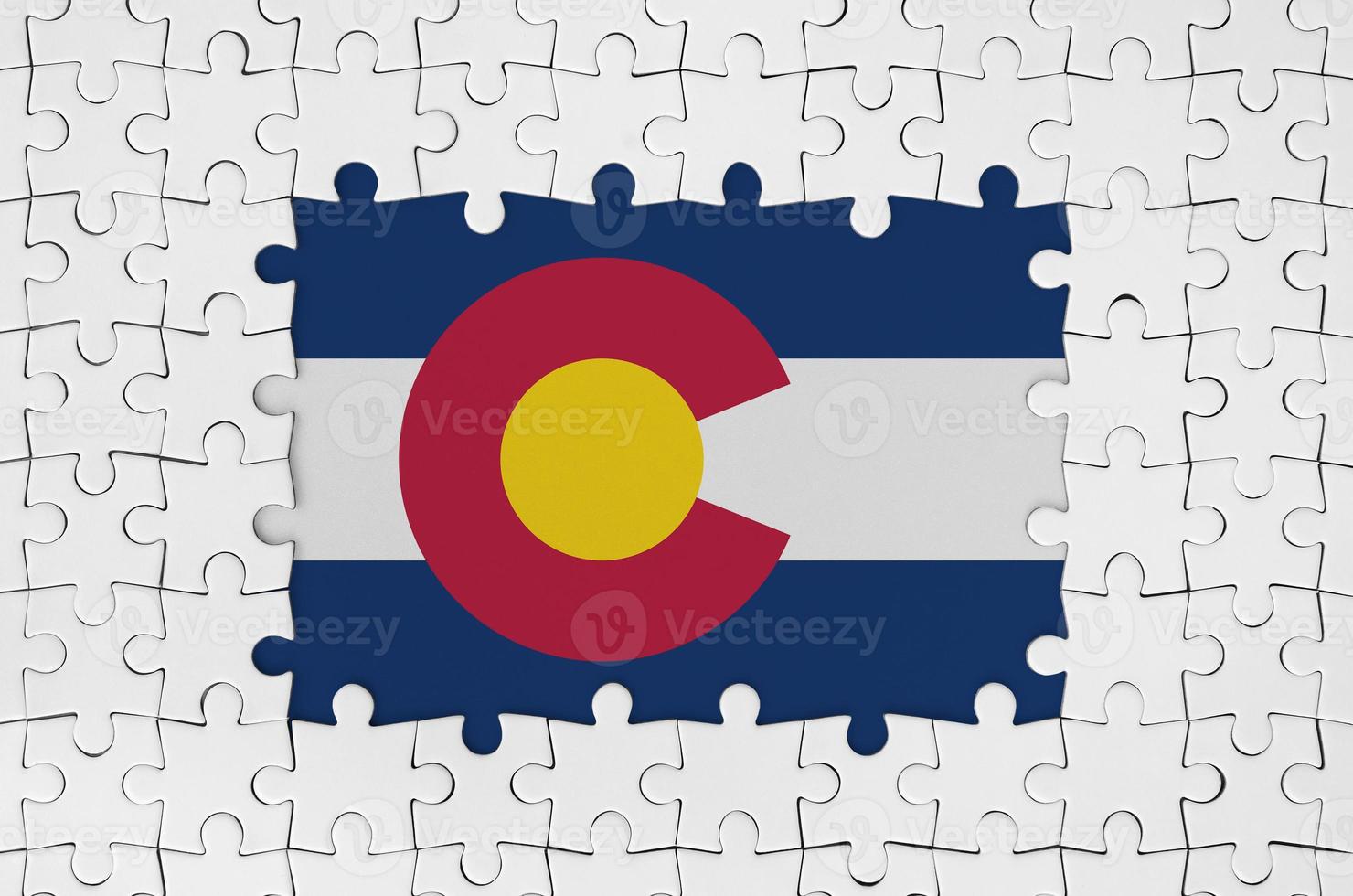 Colorado US state flag in frame of white puzzle pieces with missing central part photo