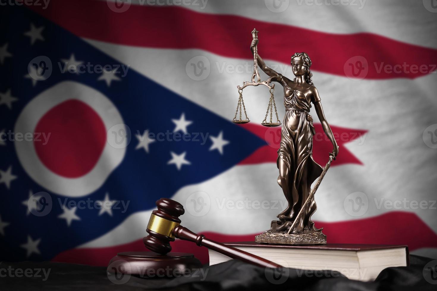 Ohio US state flag with statue of lady justice, constitution and judge hammer on black drapery. Concept of judgement and guilt photo