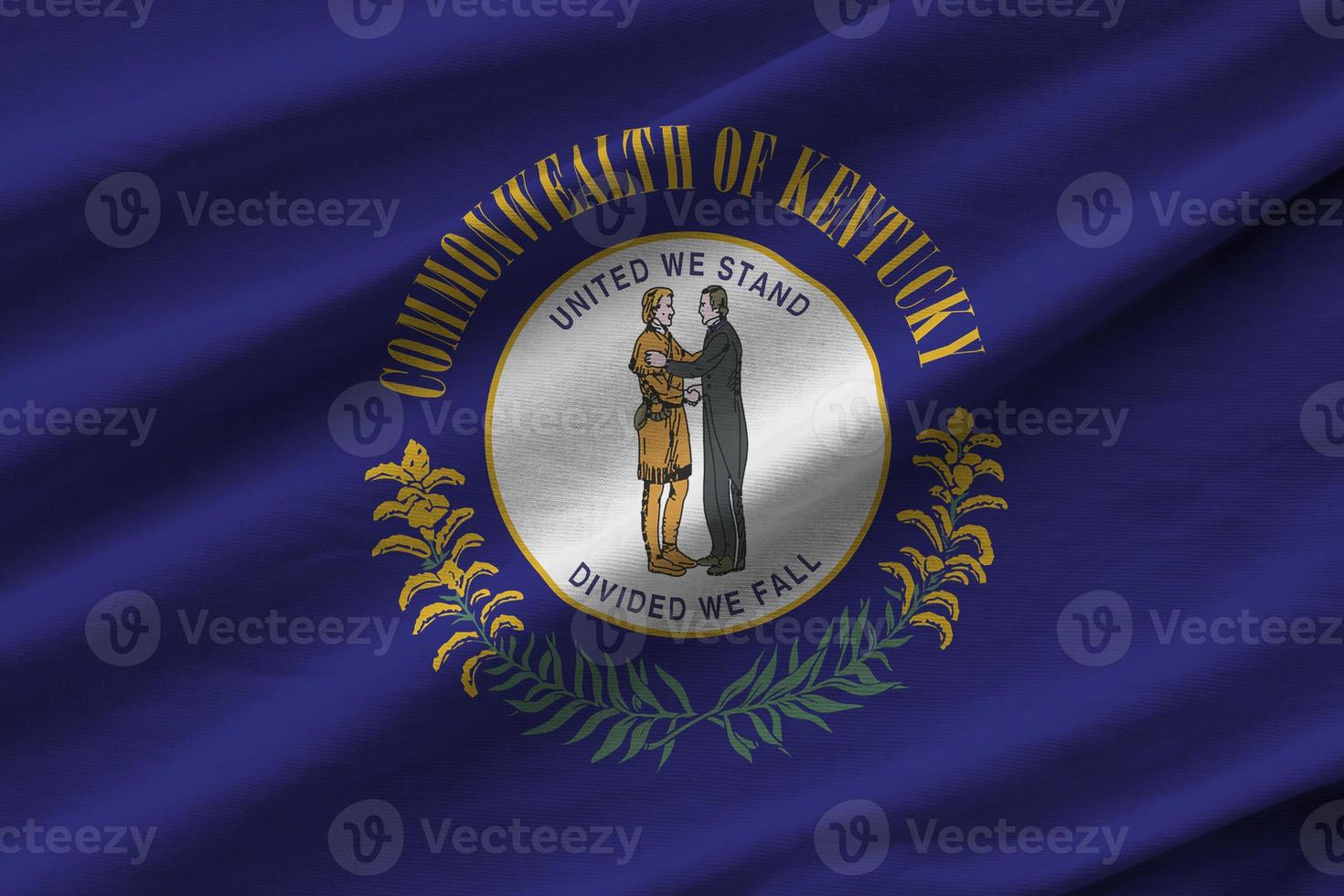 Kentucky US state flag with big folds waving close up under the studio light indoors. The official symbols and colors in banner photo