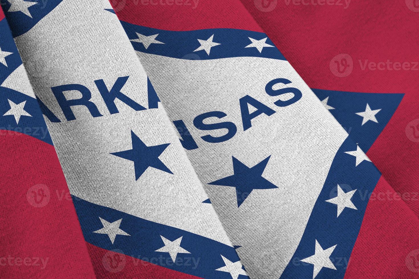 Arkansas US state flag with big folds waving close up under the studio light indoors. The official symbols and colors in banner photo