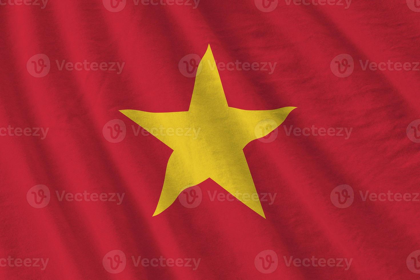 Vietnam flag with big folds waving close up under the studio light indoors. The official symbols and colors in banner photo