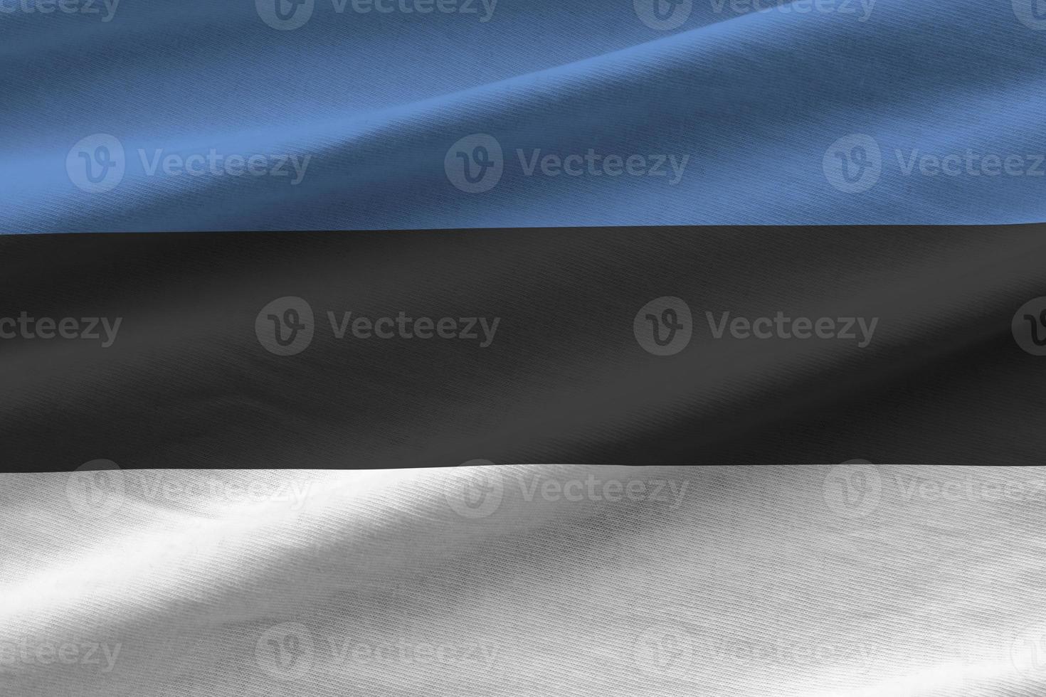 Estonia flag with big folds waving close up under the studio light indoors. The official symbols and colors in banner photo