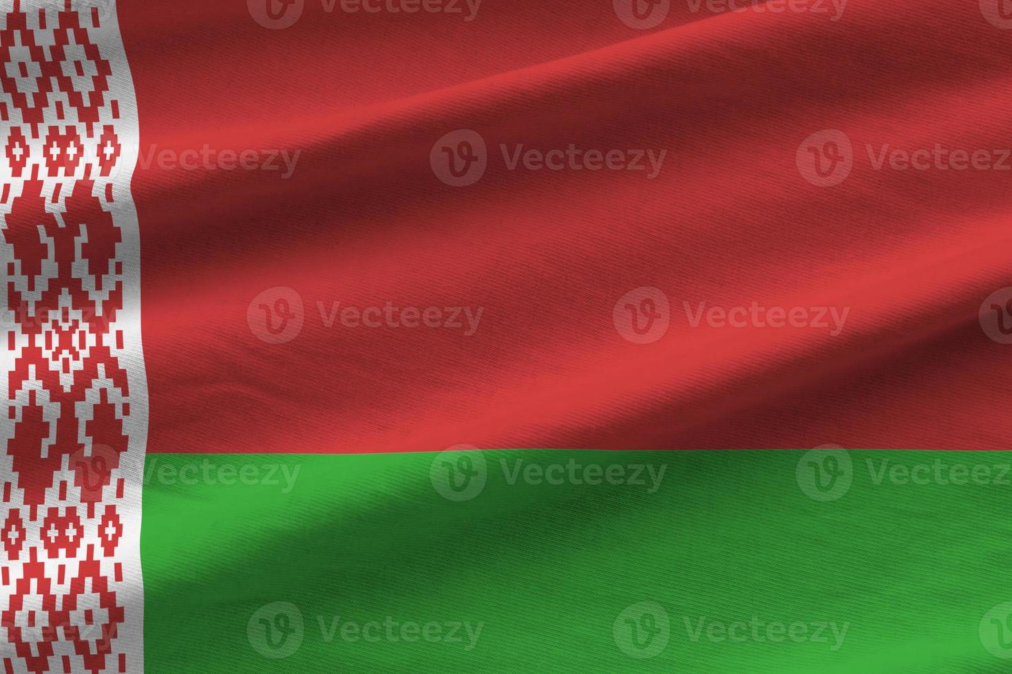 Belarus flag with big folds waving close up under the studio light indoors. The official symbols and colors in banner photo