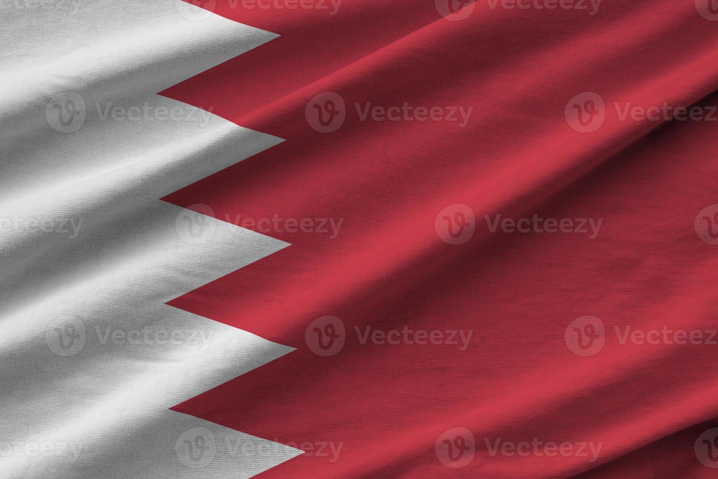 Bahrain flag with big folds waving close up under the studio light indoors. The official symbols and colors in banner photo
