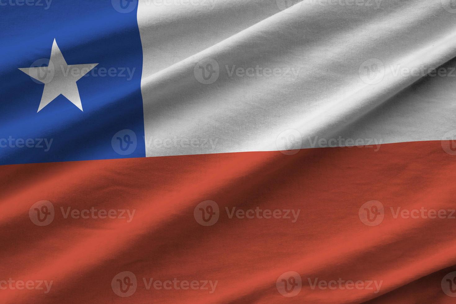 Chile flag with big folds waving close up under the studio light indoors. The official symbols and colors in banner photo