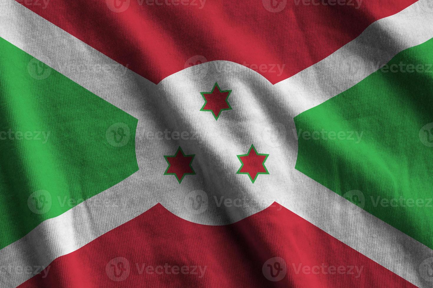 Burundi flag with big folds waving close up under the studio light indoors. The official symbols and colors in banner photo