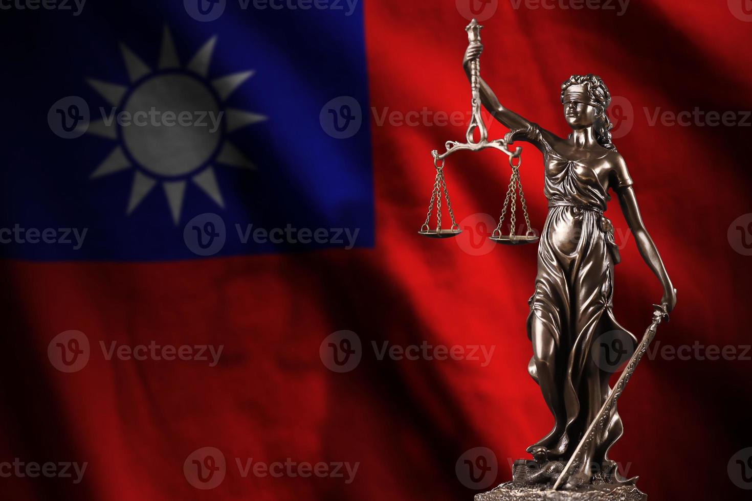 Taiwan flag with statue of lady justice and judicial scales in dark room. Concept of judgement and punishment photo