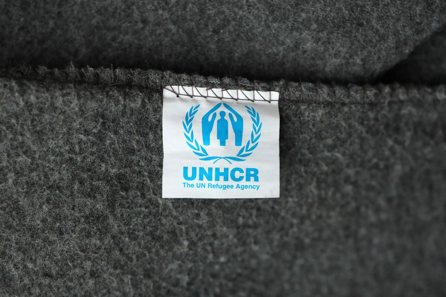 KYIV, UKRAINE - MAY 4, 2022 UNHCR The UN Refugee Agency logo on humanitarian grey blankets photo