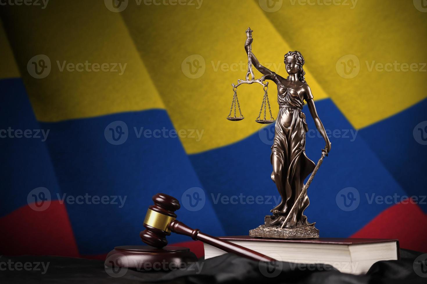 Colombia flag with statue of lady justice, constitution and judge hammer on black drapery. Concept of judgement and guilt photo