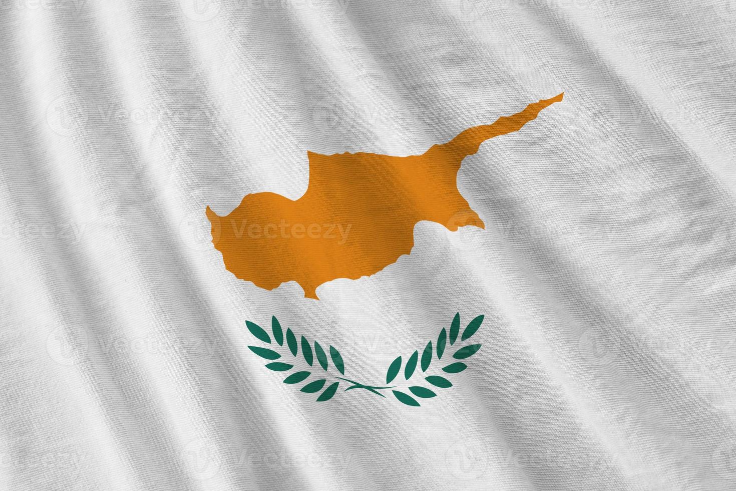 Cyprus flag with big folds waving close up under the studio light indoors. The official symbols and colors in banner photo