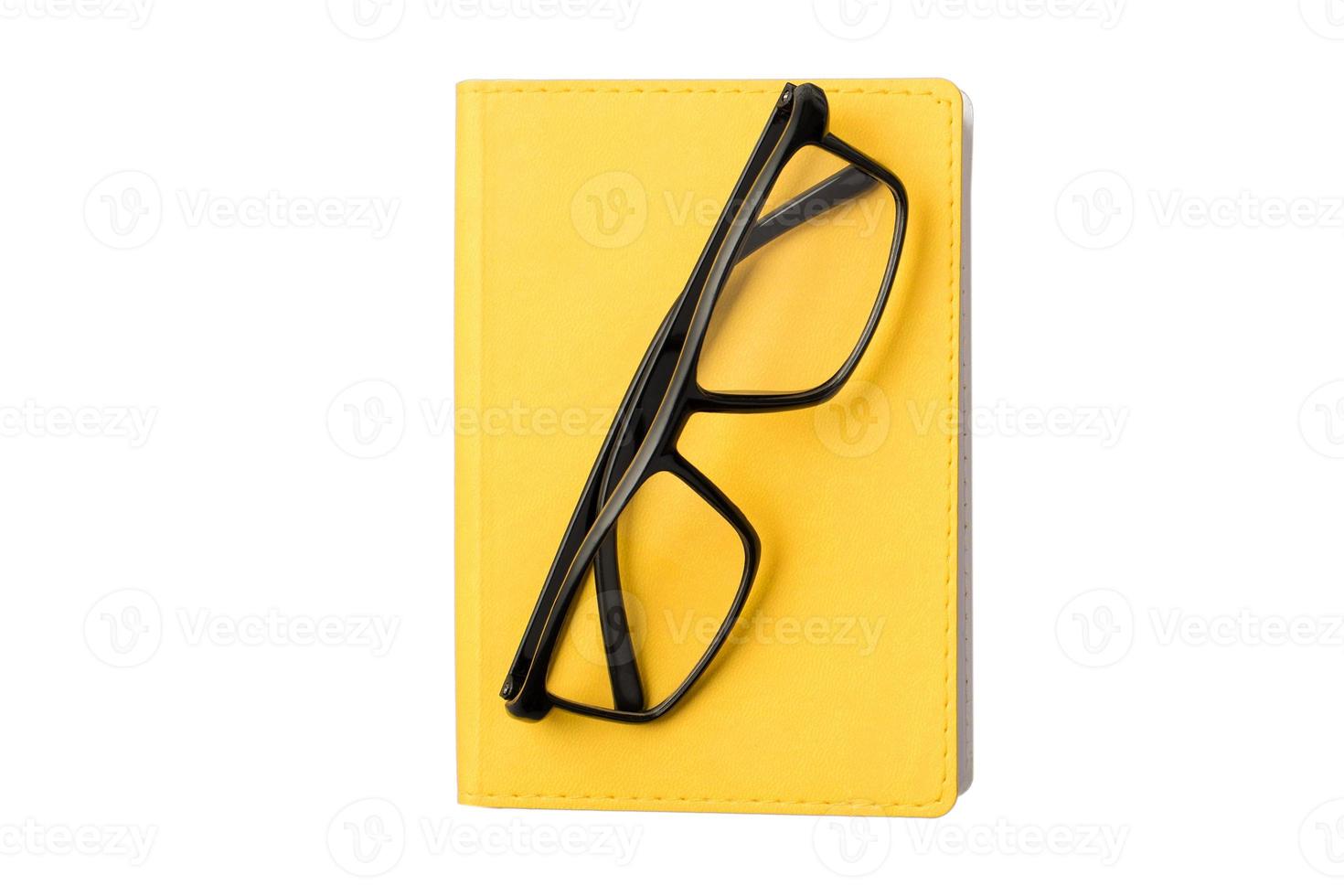 1647 Yellow notebook and black glasses isolated on a transparent background photo