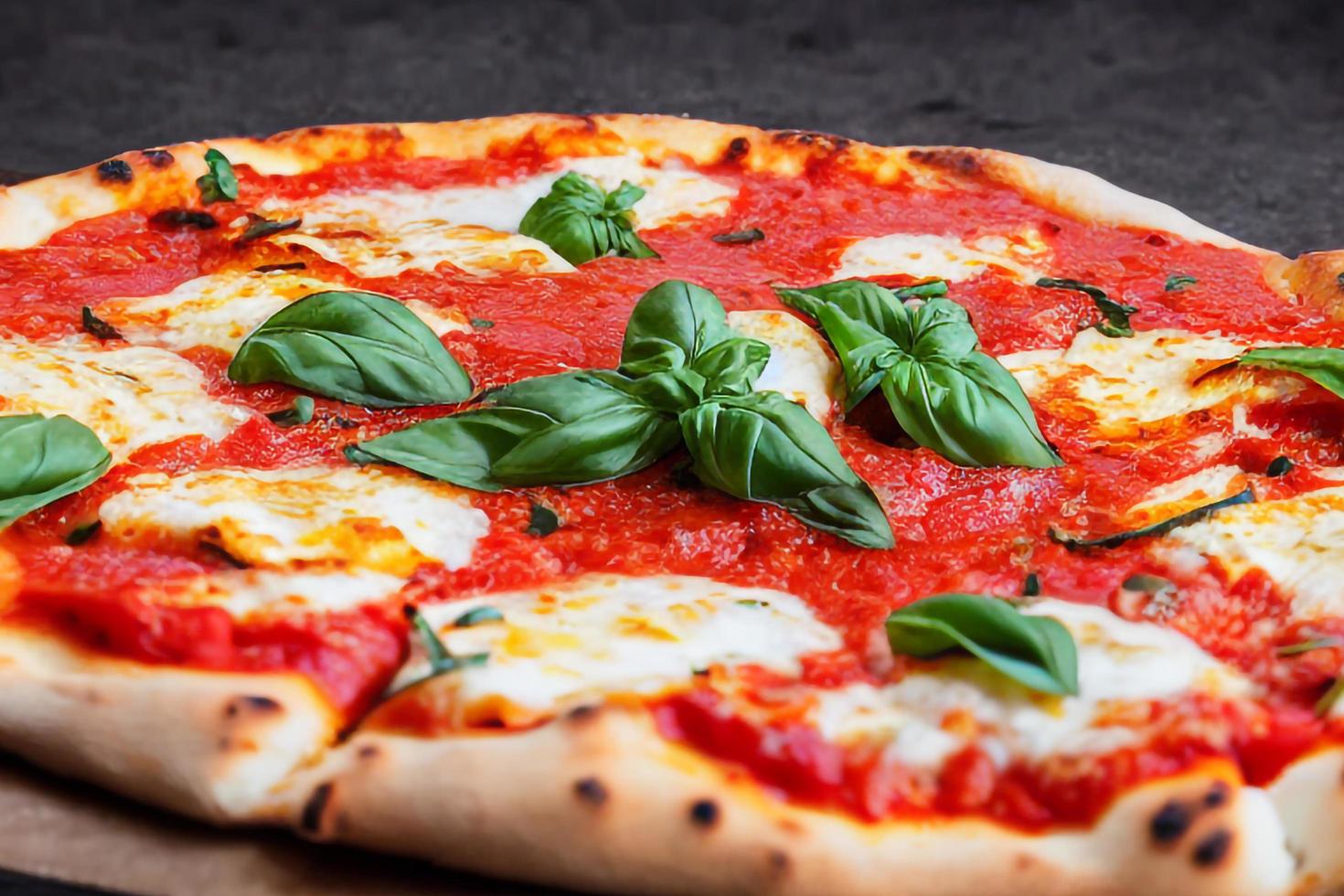 Italian pizza Margherita with tomato sauce Mozzarella cheese basil on a dark concrete background. Pizza recipe and menu. photo