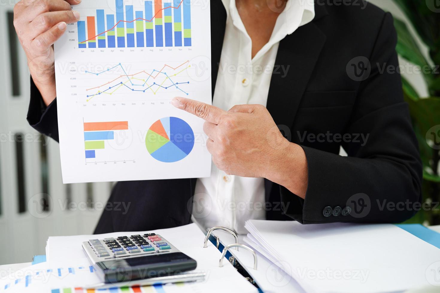 Business woman working and analysis with statistic graph in office. photo