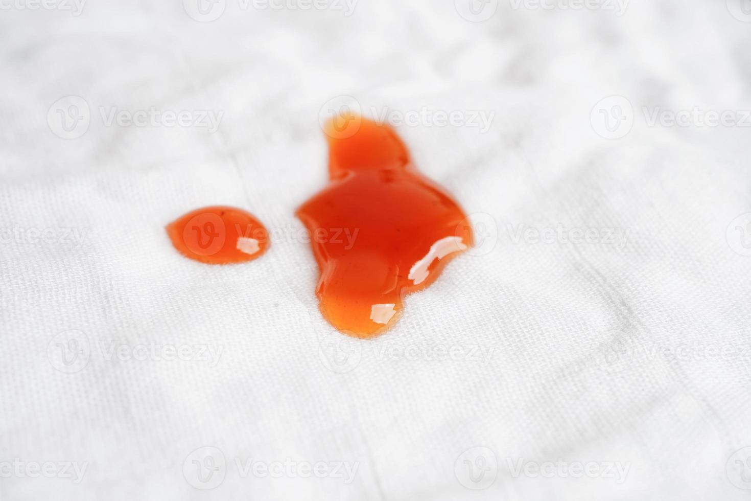 Dirty tomato sauce stain or ketchup on cloth to wash with washing powder, cleaning housework concept. photo