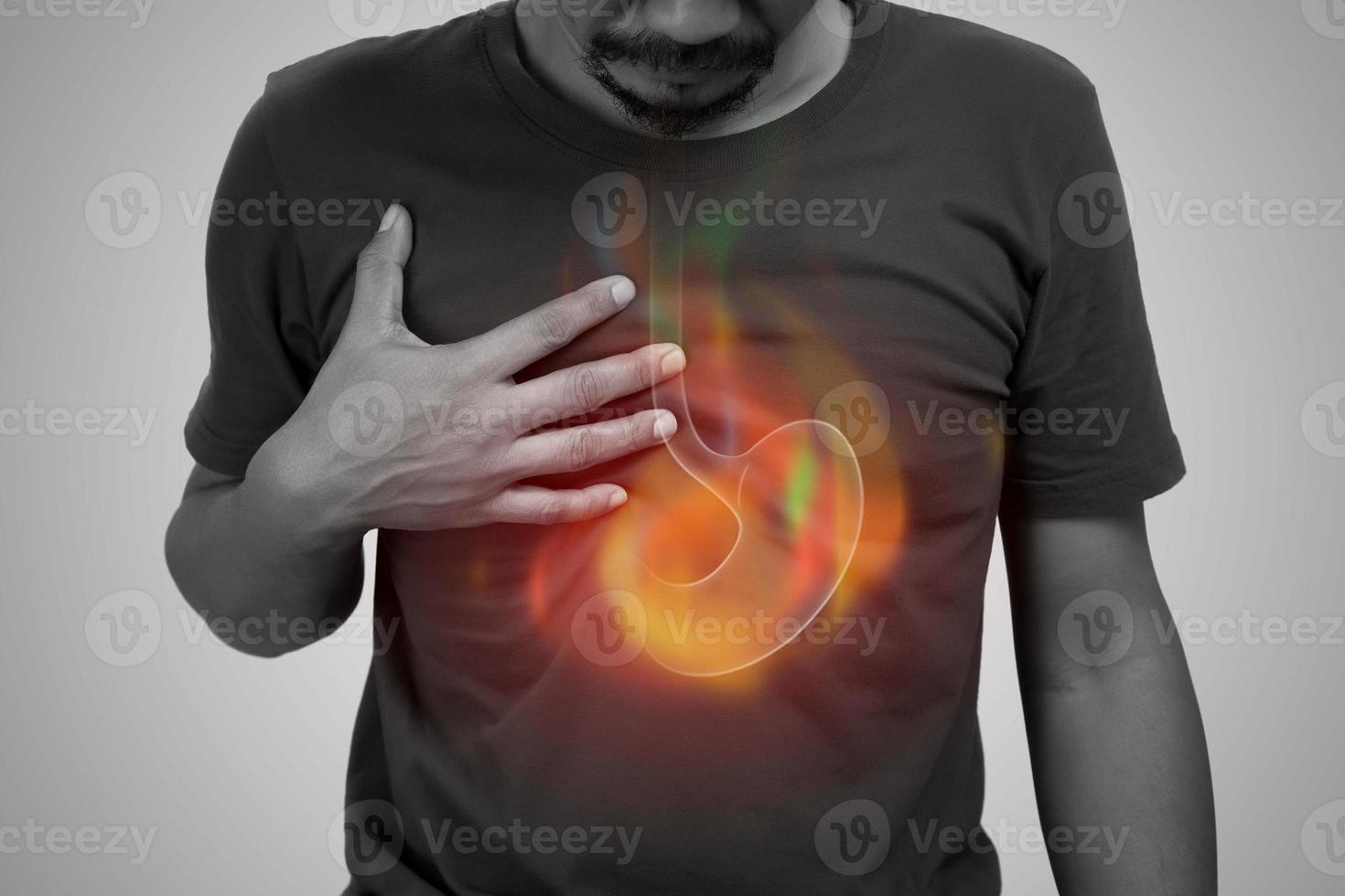 A man burning sensation in the of the middle chest because of acid reflux. Hot in middle chest caused by hyperacidity. photo