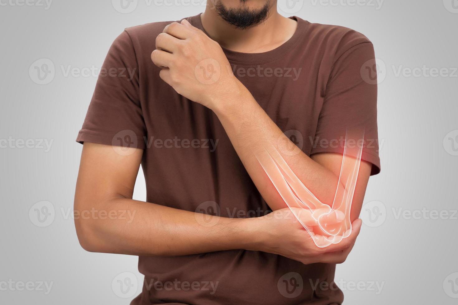 A man elbow bone ache, People suffering from pain in cubit on a gray background. Diseases of the elbow joint. Osteoarthritis photo