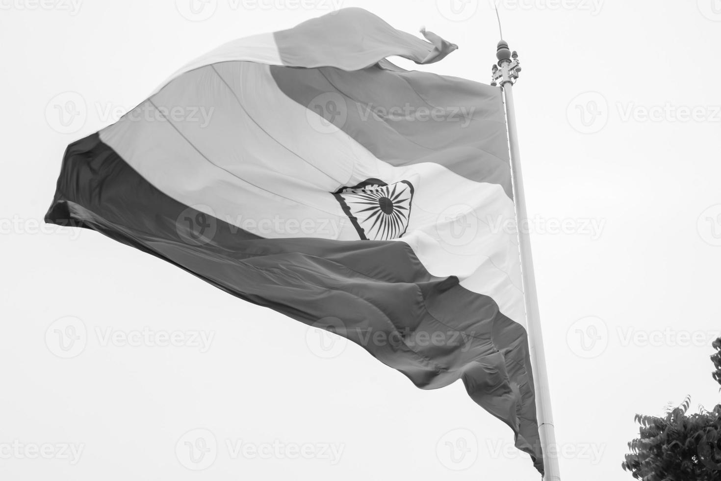 India flag flying high at Connaught Place with pride in blue sky, India flag fluttering, Indian Flag on Independence Day and Republic Day of India, tilt up shot, Waving Indian flag, Har Ghar Tiranga photo