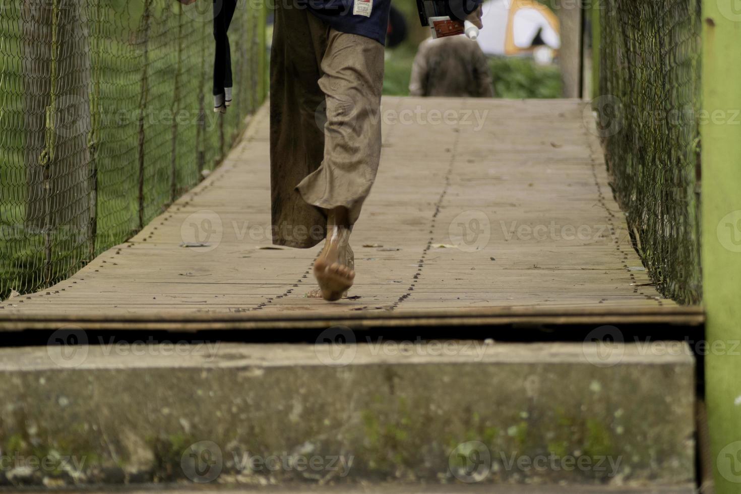 village people walking on the bridge photo