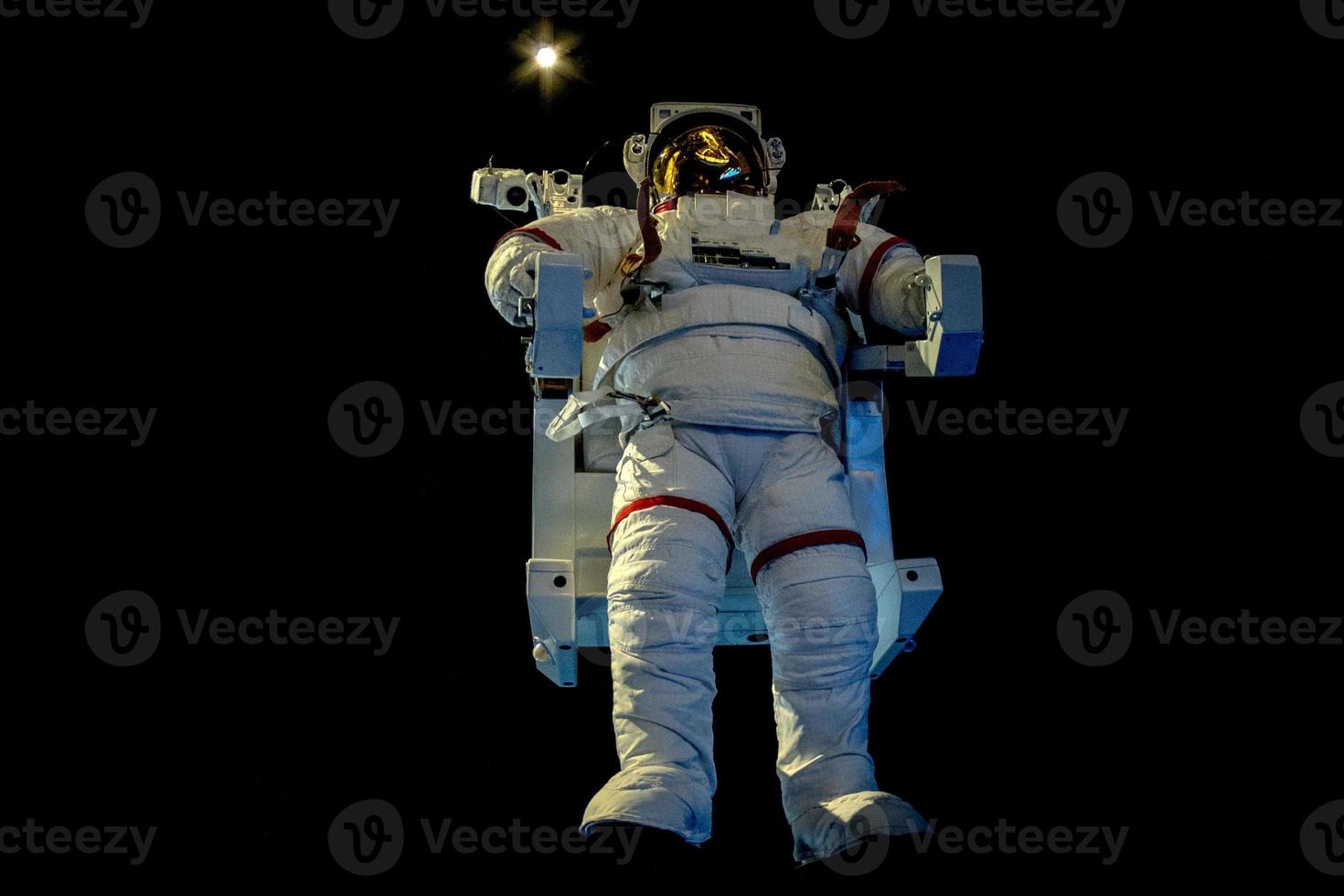 Astronaut Space Suit isolated while floating on black photo