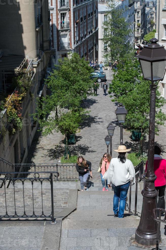 PARIS, FRANCE - MAY 1 2016 - Montmartre stairway crowded of people for sunday sunny day photo