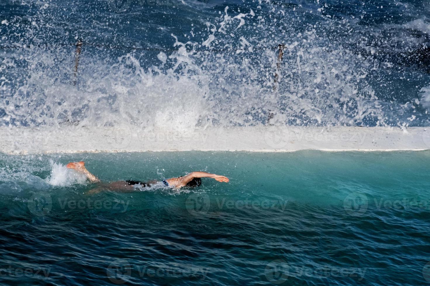 An isolatesd swimmer in a close vy the sea pool photo