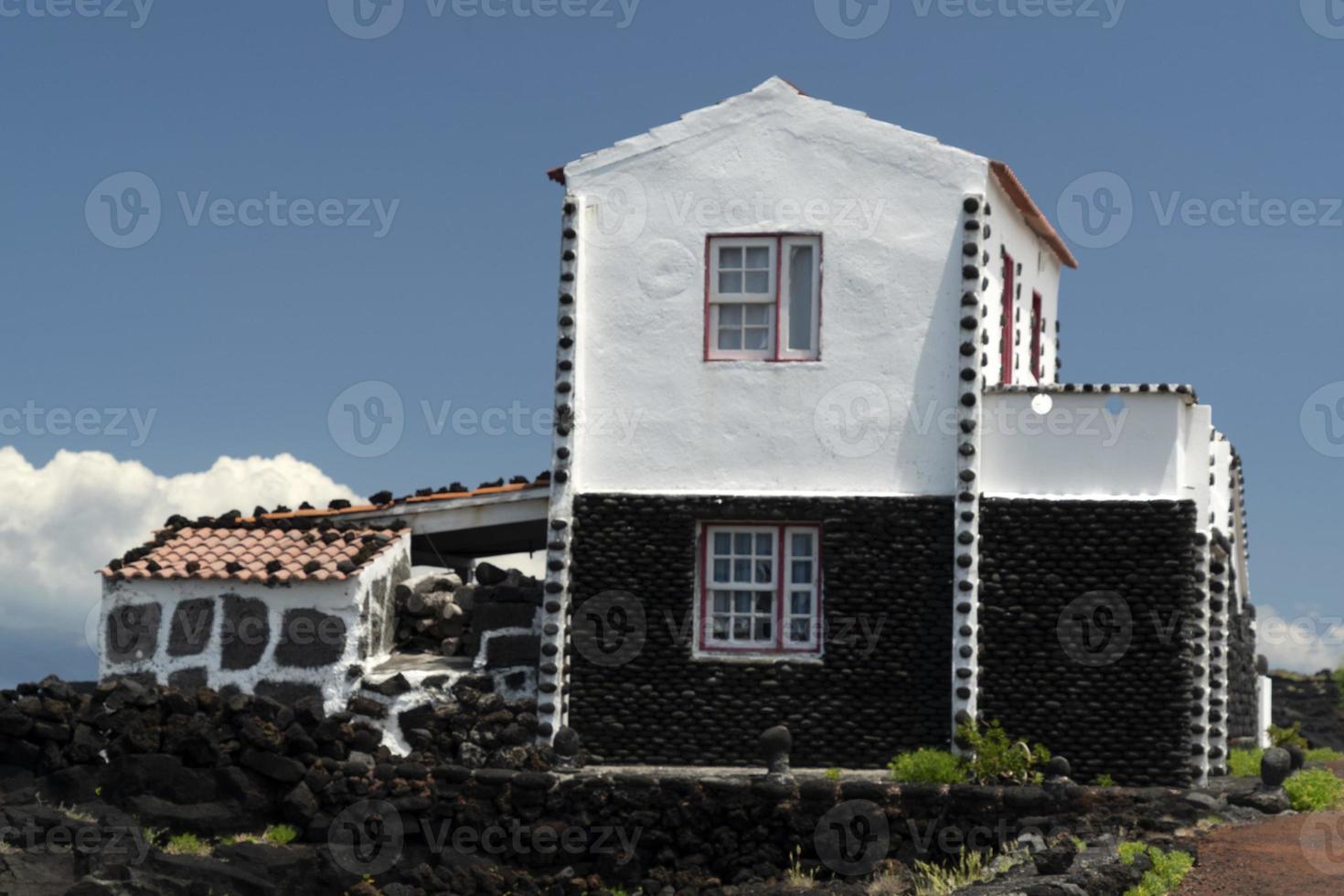 Lajido village Pico Island Azores black lava houses red windows photo