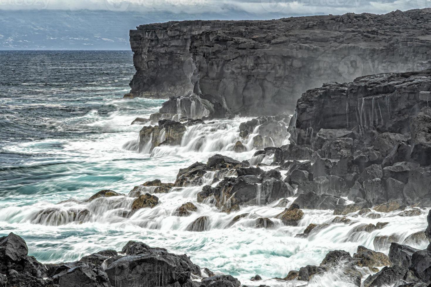 pico island waves on lava cliffs photo