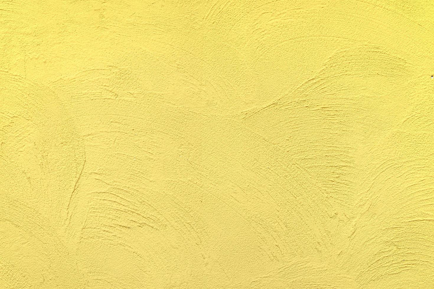 fondo amarillo de la pared de ladrillo, fondo de yeso de textura cemento hormigón, mortero ámbar abstracto colores sólidos viejos ásperos. foto